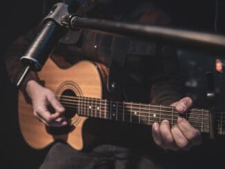 man playing guitar talking about Chicago, the Blues and Mental Health