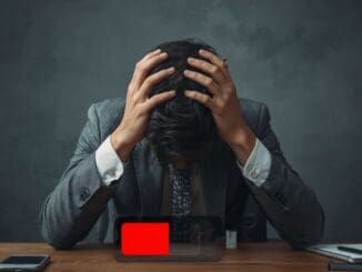 employee at desk burned out from work captured by calm anxiety clinic
